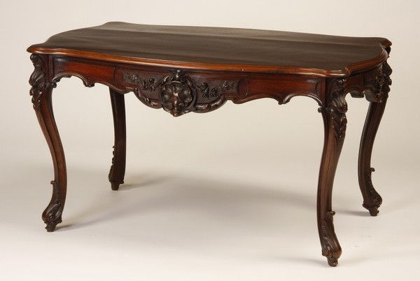 19th c. French rosewood center table: 19th century Louis XV-style rosewood serpentine top center table with shell carved apron, and single freize drawer on one side, raised on cabriole legs with carved foliate knees terminating in relief