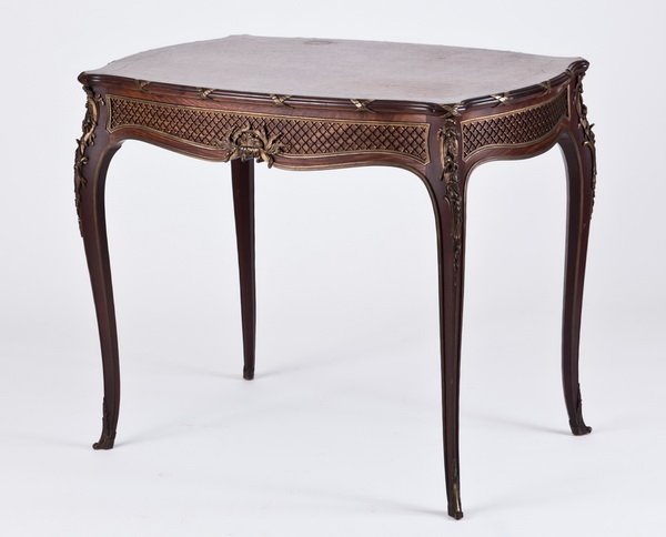19th c. French bronze mounted center table: Late 19th century French gilt bronze mounted parquetry inlaid center table, the top bordered in a reed and ribbon design, the apron with finely chiseled bronze mounts in a lattice pattern, all raised 