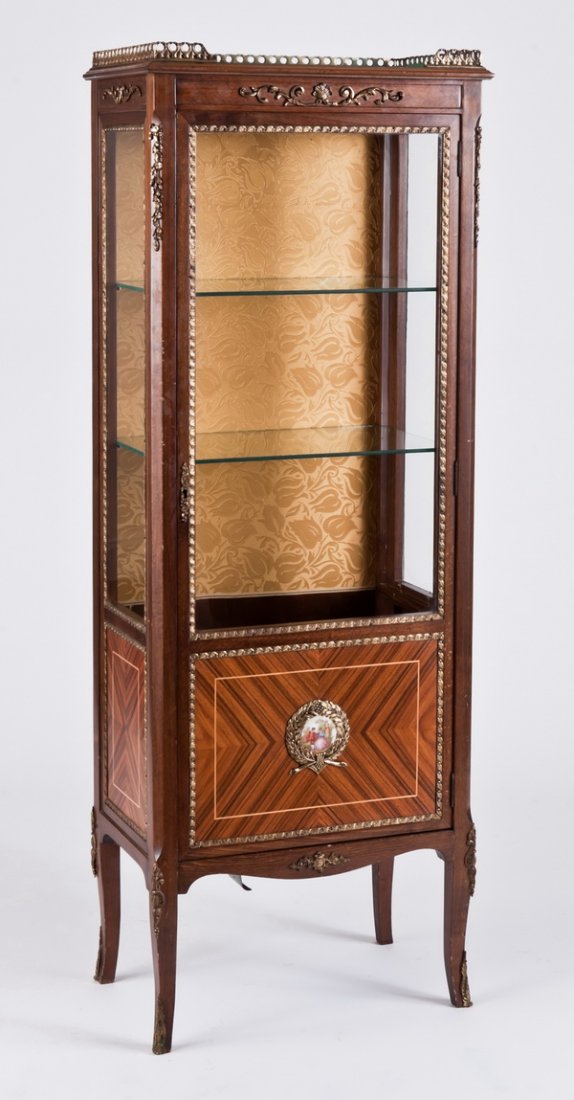 19th c. bronze mounted curio cabinet: Late 19th century Louis XVI style bronze mounted walnut and satinwood curio cabinet with pencil inlays and porcelain plaque depicting a courting couple, the interior lined with gold silk damask, 60"h 