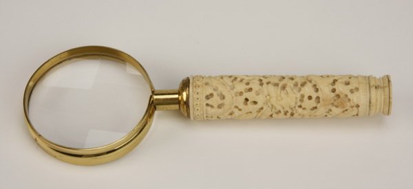 19th c. ivory handled magnifying glass: 19th century handheld magnifying glass with a round, carved ivory handle, 7.5"l x 2.5" diameter glass.