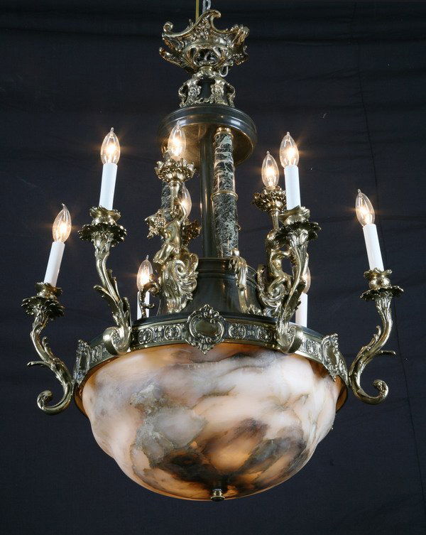 Early 20th c. bronze and alabaster chandelier: Early 20th century 9-light bronze and alabaster chandelier with three central verde marble columns flanked by bronze putti holding candelabra, 40"h x 22"diam.