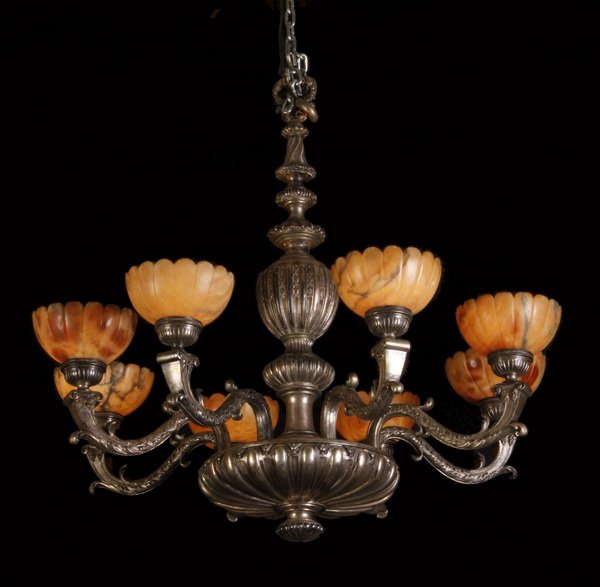 Early 20th c. bronze and alabaster chandelier: Early 20th century silver over bronze 8 arm chandelier with carved alabaster shades, 32"h x 34" diameter.