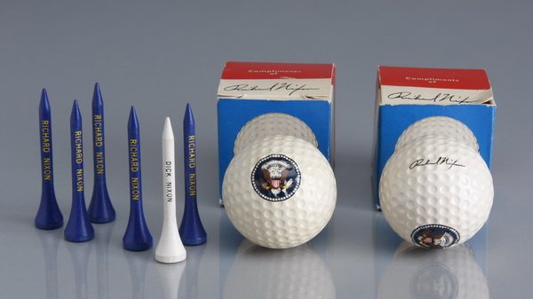 Nixon White House golf balls and golf tees: Nixon White House golf balls and tees, the two golf balls in their original boxes, each ball imprinted with a full color Presidential seal and Richard Nixon's signature, the boxes marked "Compliments 