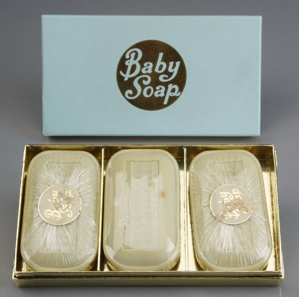 John F. Kennedy Jr.'s boxed baby soap: Gift box of "John John's" (John F. Kennedy Jr.'s) baby soap, 3 unused bars in their original shrink wrap, each with a molded design of the White House on one side and "Baby Soap" on the reverse, in th