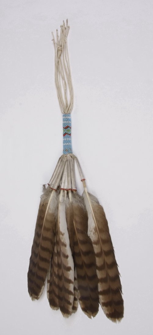 Early 20th c. Peyote loose 12-feather fan: Early to mid 20th century Peyote ceremonial deer hide loose 12-feather fan, the handle decorated with beadwork and fringe below, 20"l. In the Native American Church the fan serves as an intermediary b
