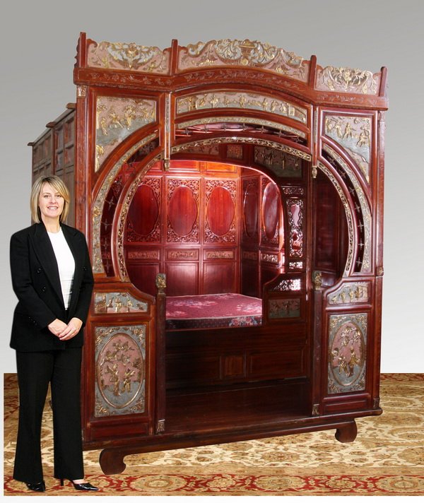 19th c. Chinese wedding bed: Late 19th century Chinese wedding bed with pierce carved crest and parcel gilt relief carved figural panels surrounding the facade. The interior is divided into two areas - one for placing one's perso