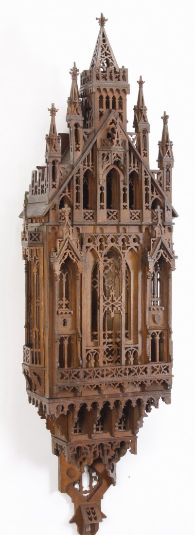 20th c. Gothic Revival wall décor, 59"h: 20th century large Gothic Revival wall mounted architectural decoration, crafted of walnut stained wood, with high style elements of arched windows, parapets, and tracery, 59"h x 17"w x 10"d.