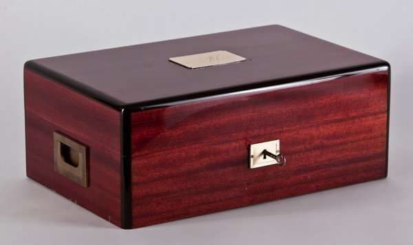 Davidoff mahogany humidor, maker marked: Davidoff locking mahogany humidor with brass hardware, interior lift-out tray and humidifier, maker marked, brass plate on lid monogrammed "M", 5.5"h x 13.5"w x 9"d.