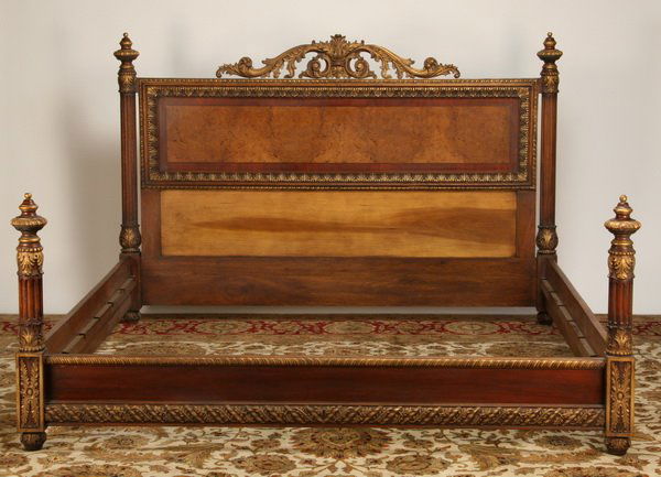 North Carolina Furniture Showroom Sample: Carved and parcel gilt king size Louis XV-style mahogany and burl walnut bed, the headboard with oversized scrolling acanthus leaf crest flanked by fluted posts with turned finials, relief carved thro