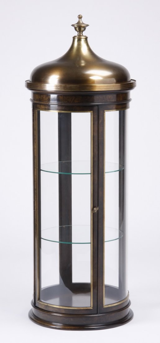 Mid 20th c. cylindrical lighted vitrine: Mid century modern cylindrical vitrine by Mastercraft / Baker Furniture, with burl amboyna wood veneer, curved glass panels, and aged brass domed cap, the interior with two round glass shelves illumin