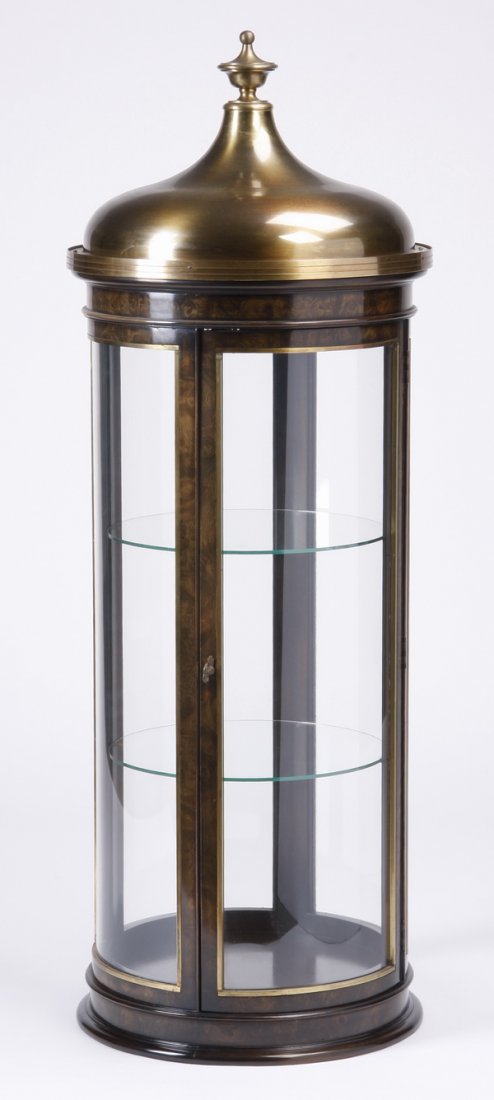 Mid 20th c. cylindrical lighted vitrine: Mid century modern cylindrical vitrine by Mastercraft / Baker Furniture, with burl amboyna wood veneer, curved glass panels, and aged brass domed cap, the interior with two round glass shelves illumin