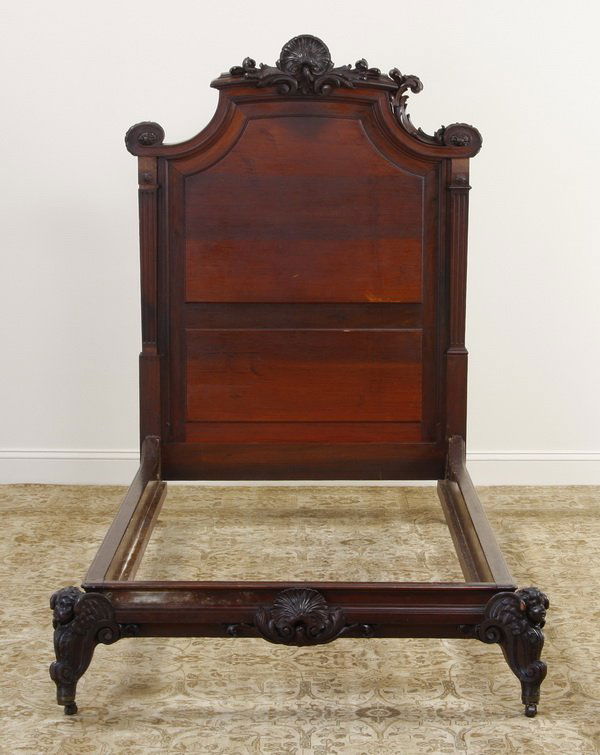 19th c. American Rococo mahogany single bed: Late 19th century American Rococo Revival carved mahogany single bed featuring a central carved shell at the headboard and footboard, the footboard with winged angel-shaped legs, 65"h x 88"l x 48"w.