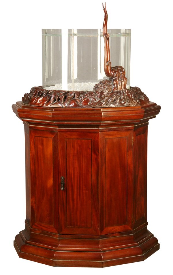 Glass terrarium with mahogany base, 59"h: Glass terrarium supported by a carved mahogany base depicting a rock outcropping, on a 10 sided pedestal base with storage compartment, 59"h x 41" diam at the base.