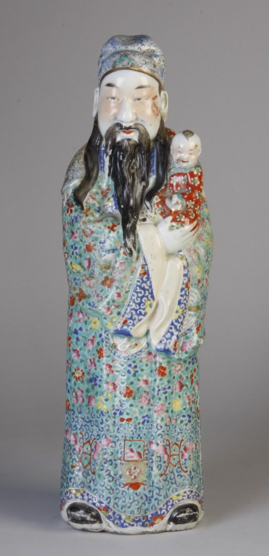 Early 20th c. Chinese stoneware figure: Early 20th century Chinese earthenware figure of an elder clothed in a full length aqua colored robe adorned with multi-colored flowers and holding a small child, 18.5"h x 5.5"w x 4"d at the base (som