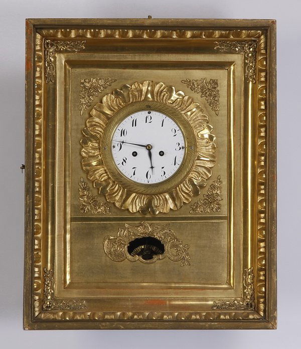 Mid 20th c. French gilt wood wall clock: Mid 20th century French gilt wood wall clock, with floral accents and gadrooning around the edge, the pendulum in the shape of a face encircled by sun rays, unmarked, 17"h x 14"w x 5"d.