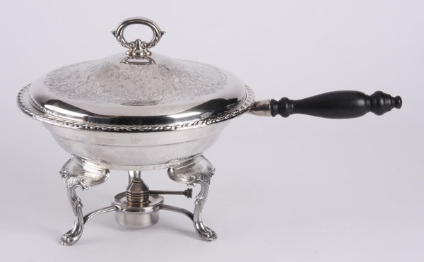 Wm. A. Rogers silver plated chafing dish: 20th century American silver plated chafing dish, the pan with an ebonized wood handle and gadrooned verge, the removable lid with etched scrollwork and foliate designs, all over a tripod stand with c