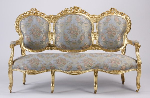 Late 19th c. Rococo Revival gilt wood sofa: Late 19th century French Rococo Revival triple chair back gilt wood canape' with asymmetrical pierce carved scrolling crests and serpentine apron all over cabriole legs, the tight backs and seat uphol