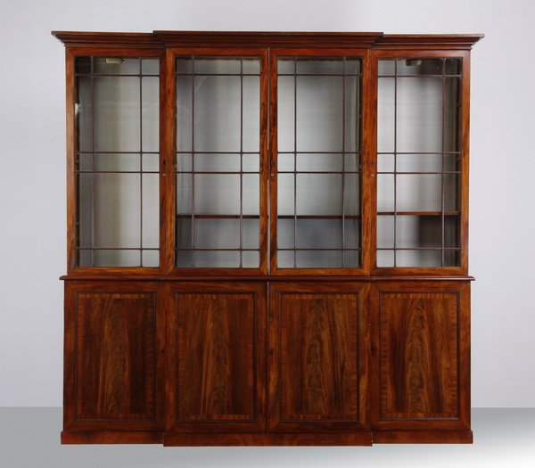 Late 18th c. Georgian mahogany bookcase: Late 18th or early 19th century Georgian style mahogany four door breakfront bookcase, the molded cornice above four glass panel doors with individually mullioned panes, all over four recessed panel f