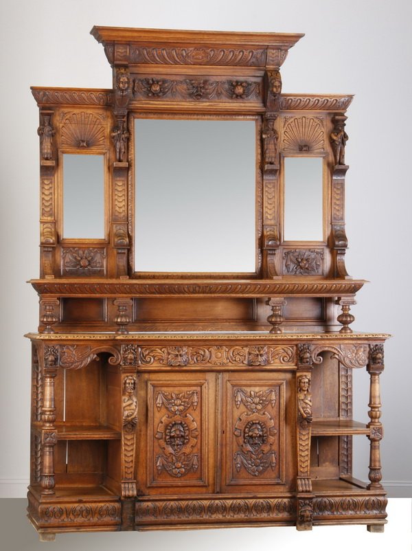 19th c. French Renaissance Revival oak buffet: 19th century French Renaissance Revival carved quarter sawn oak buffet, the upper cabinet with three beveled glass mirrors interspaced with gadrooning, relief carved drapery swags, and fully formed mu
