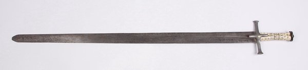 (2) Early 20th c. decorative swords: Pair of early 20th century decorative swords, includes (1) flat, double edged sword, the bone handle carved with circular designs, blade 38"l, overall size including handle 43.5"l x 5.5"w, and (1) cas