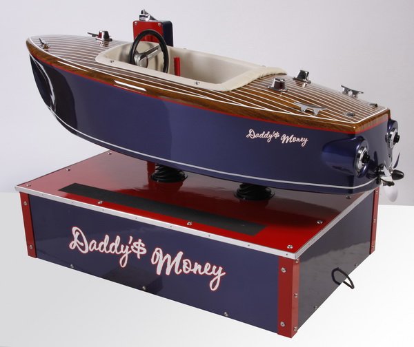 Coin operated children's mechanical ride: 20th century American $.10 coin operated children's mechanical ride in the shape of a Chris-Craft runabout boat named "Daddy's Money", crafted of fiberglass with leather seat and metal base, 36"h x 71