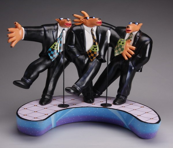 Markus Pierson signed sculpture: Late 20th century polychrome painted mixed media sculpture, from the Coyote series, depicting a trio of sharply dressed coyote singers, on a crescent shaped base, signed by the artist Markus Pierson (