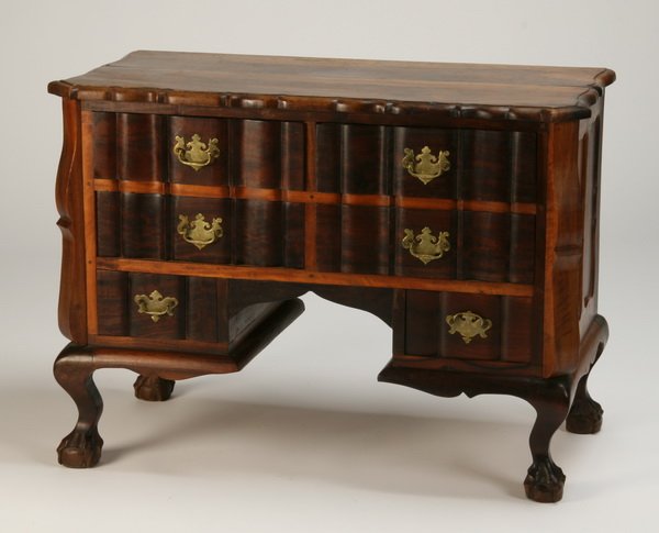20th c. British Colonial mahogany chest: Early 20th century British Colonial inspired six drawer serpentine shaped mahogany chest on cabriole legs terminating in ball and claw feet, 29"h x 40"w x 19.5"d.