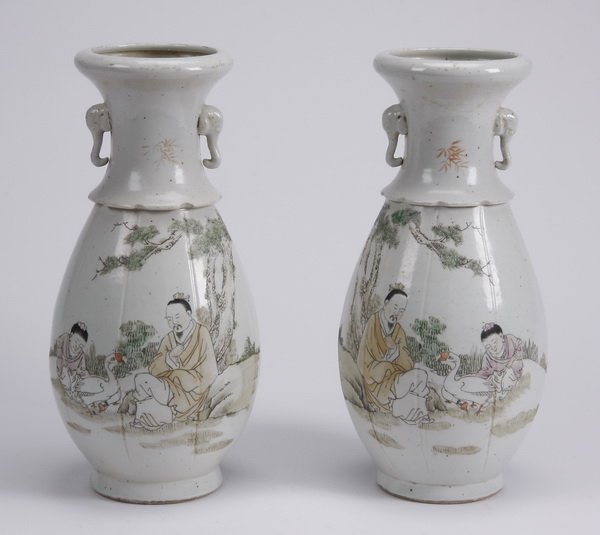 (2) Early 20th c. Chinese hand painted vases: Pair of early 20th century Chinese hand painted ceramic vases, of baluster form with elephant head handles and scalloped detail at the neck, the vases with mirror image scenes of a seated male and fem
