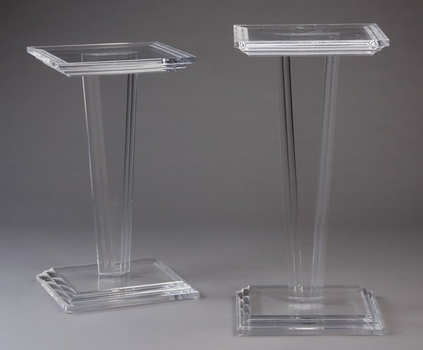 (2) Lucite pedestals: Two contemporary transparent lucite "Viking" pedestals, made by Haziza, the rectangular molded cornice top over a tapered stem on a stepped rectangular base, (1) 32.5"h x 18"w x 10"d, (1) 36.25"h x 18