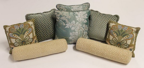 (8) Custom designed throw pillows: Group of eight decorative throw pillows, custom designed by Penny Drue Baird and her firm Dessins, includes (2) 20"h x 20"w, (2) 17"h x 17"w, (2) 15"h x 15"w, and (2) bolsters 24.5"l x 10"w.