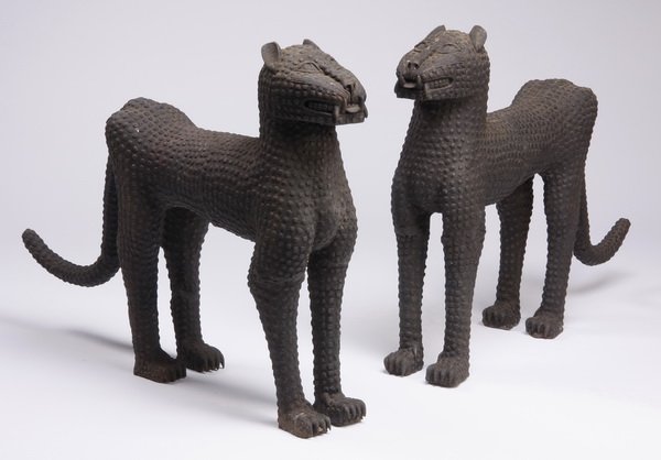 (2) 30"h stylized African jungle cats: Pair of 20th century African figural metal sculptures in the form of stylized jungle cats, with textured surfaces, 30"h x 43"l x 9"w.