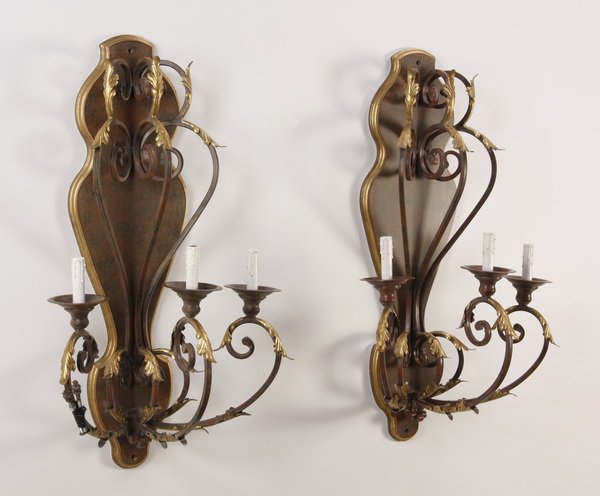 (2) Gilt wood and metal wall sconces: Pair of 20th century wood and metal electrified three-light wall sconces, the serpentine arms with gilt acanthus leaves against a decorative mottled ground with gilt border, 40"h x 23"w x 15"d.