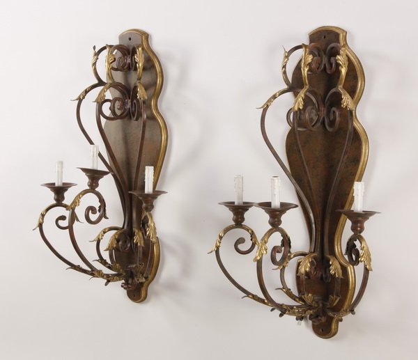 (2) Gilt wood and metal wall sconces: Pair of 20th century wood and metal electrified three-light wall sconces, the serpentine arms with gilt acanthus leaves against a decorative mottled ground with gilt border, 40"h x 23"w x 15"d.
