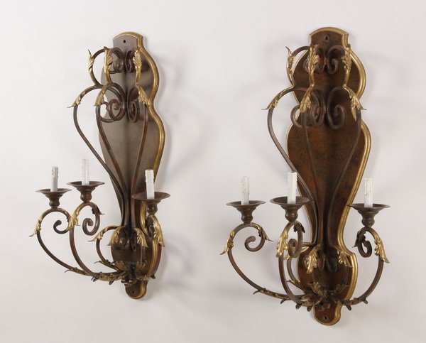 (2) Gilt wood and metal wall sconces: Pair of 20th century wood and metal electrified three-light wall sconces, the serpentine arms with gilt acanthus leaves against a decorative mottled ground with gilt border, 40"h x 23"w x 15"d.