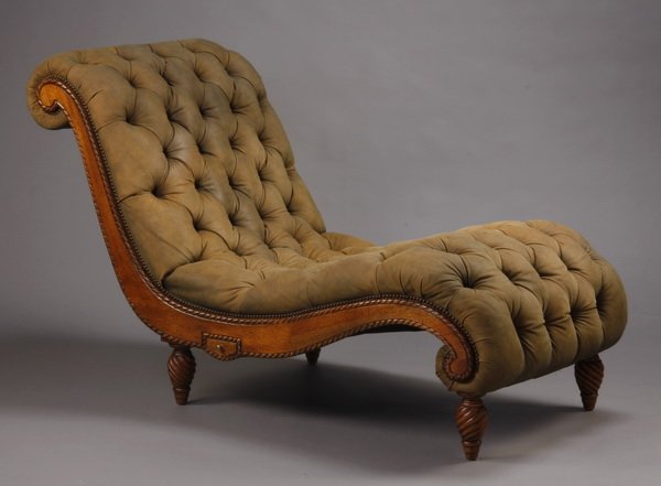 Contemporary button tufted chaise: Contemporary button tufted s-shaped chaise with a carved hardwood frame upholstered in brown sueded leather with nail head trim, the small hidden drawers on either side below the seat would be ideal a