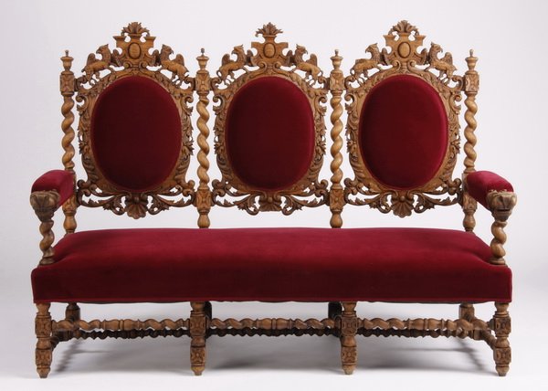 19th c. Continental pierce carved oak settee: Late 19th century Continental pierce carved oak settee, the arched backrests with central cabochon crests flanked by gryphons, with barley twist frames and stretcher bases, upholstered in dark red vel