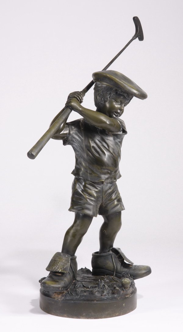 20th c. bronze figural sculpture: 20th century cast bronze sculpture of a young boy dressed in adult golf shoes and cap, with a putter in his hand, signed Jim Davidson, 40"h x 40.5"w x 19"d.