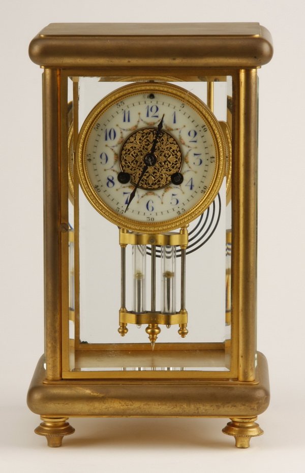 19th c. French crystal regulator clock: Late 19th century French gilt bronze crystal regulator clock with enamel decorated porcelain clock face, and original mercury filled pendulum, 12"h x 6.5"w x 5.5"d.