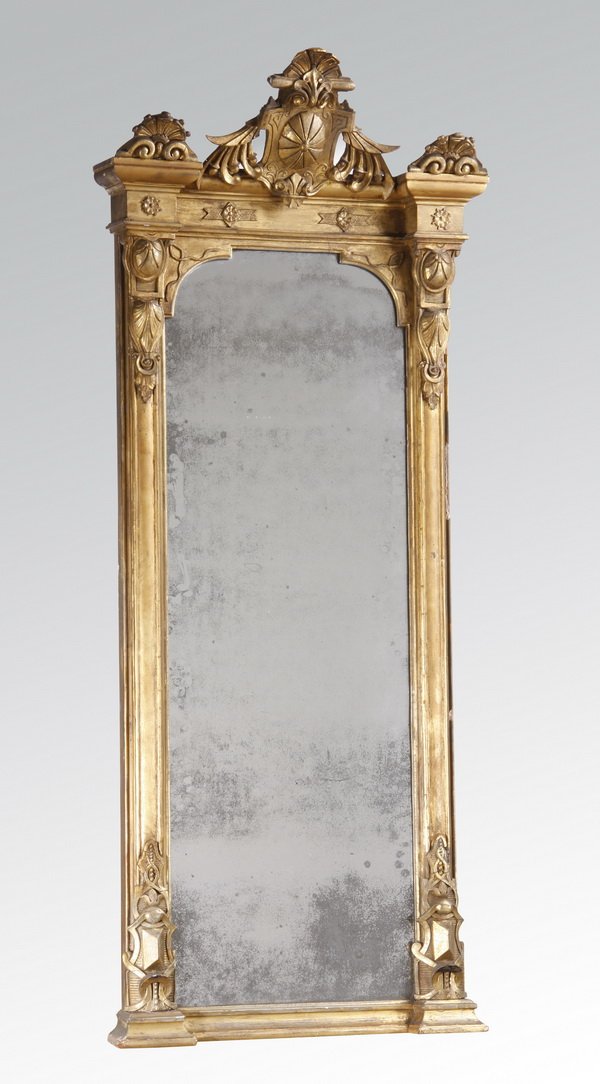 Late 19th c. gilt wood pier mirror: Late 19th century American Renaissance Revival carved and gilt pier mirror, the shell crest flanked by further shells surmounting an oval medallion within a cartouche, above a frieze with rosettes, th