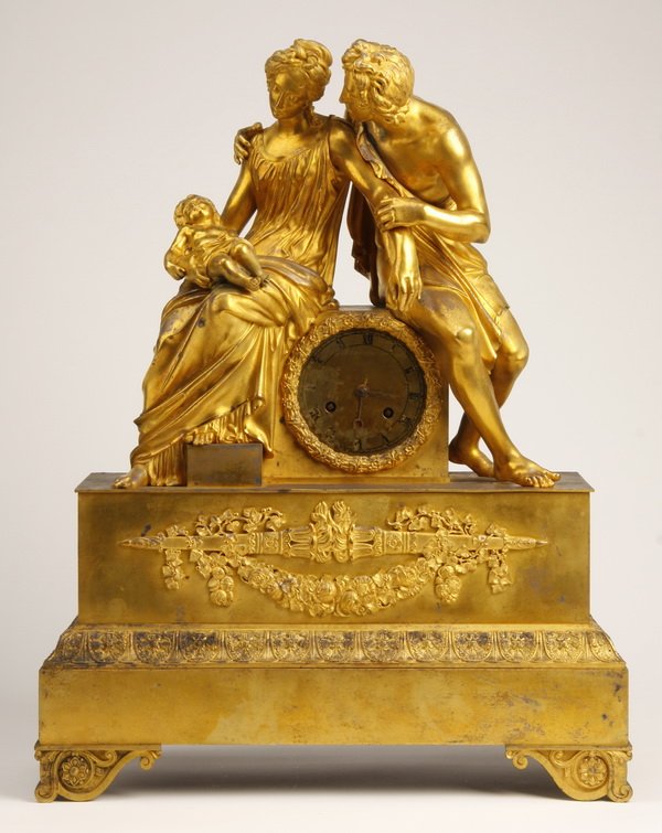 19th c. French dore' bronze figural clock: 19th century Napoleon II burnished dore' bronze figural clock, the silver gilt clock face flanked by a young couple with baby, the clock mechanism maker marked "Medaille d'Or 1827", 22"h x 17"w x 7"d.