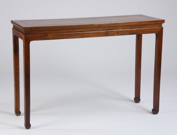19th c. Chinese huanghauli wood table: Late 19th or early 20th century Chinese huanghuali wood side table, the rectangular top above a flat apron, raised on block legs terminating in elephant feet, 32.5"h x 47.25"l x 16.5"w.