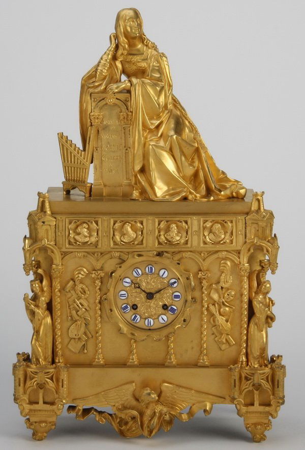19th c. French dore' bronze clock: 19th century French burnished dore' bronze clock paying tribute to Music and the Arts, the clock face with procelain Roman numerals surmounted by a seated maiden, flanked by winged angels in castle in