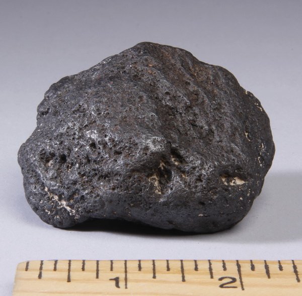 Meteorite found in Argentina: Meteorite, found in Gran Chaco, Argentina, 1.25"h x 2.5"l x 2"w.