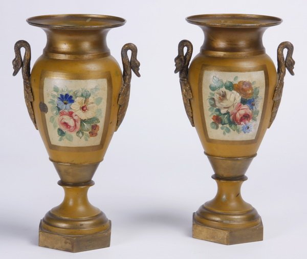 (2) 19th c. French tole urns: Pair of late 19th century French hand painted tole urns, with a flared rim and handles formed as swans, on a mustard ground with floral reserves and gilt leaf designs, raised on a socle and hexagonal