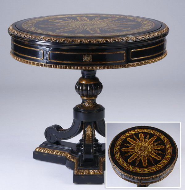 Maitland-Smith parcel gilt table: Contemporary carved and parcel gilt ebonized wood occasional table, the round top with hand worked foliate designs and inset beveled glass, over an apron with a single drawer, all raised on three acan
