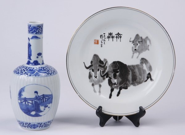 (2) Pieces of hand painted Chinese porcelain: Mid 20th century Chinese blue and white bottle vase, with scenes of ladies in courtyards, the base with K’ang Hsi mark, 10.25"h x 4.5"w; together with (1) late 20th century Chinese porcelain plate w