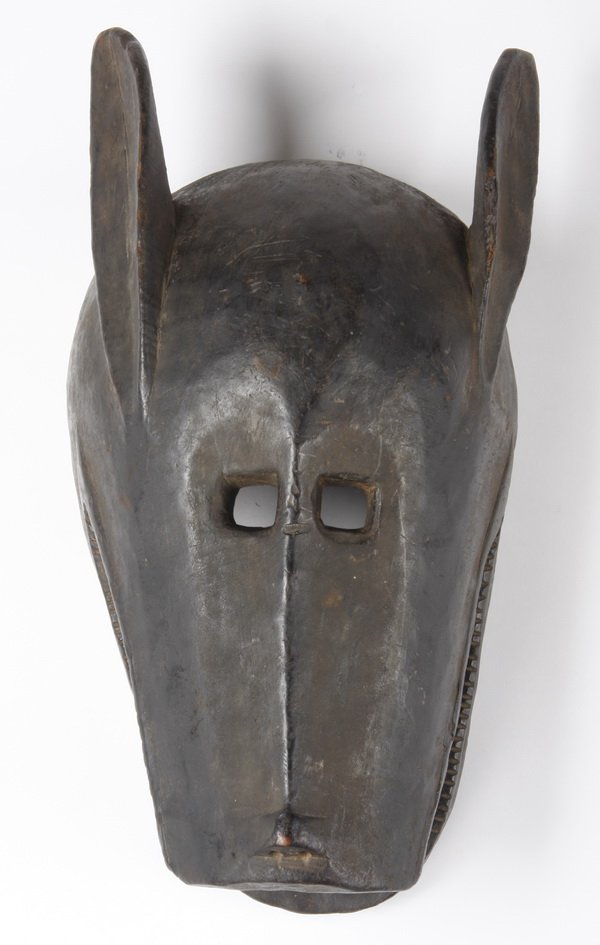 Bamana antelope mask, Mali: Bamana antelope mask, for all-male Koro society, Mali, worn during dance ceremonies, the carved and black painted wood face issuing horns, with an open and flattened mouth, 7"h x 19"l x 10"w.