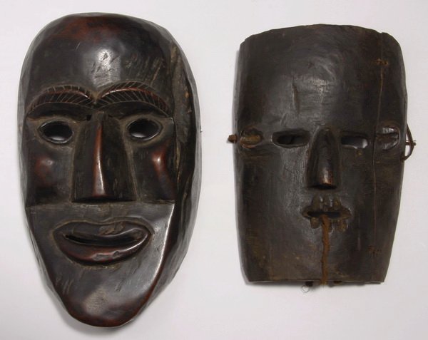(2) Himalayan dance masks: Two early to mid 20th century Himalayan dance masks, Middle Hills, Nepal, the carved wood faces with pierced eyes and mouth slits, (1) 11"h x 7"w x 3.5"d and (1) 9.25"h x 6.5"w x 2"d.