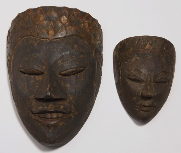 (2) Minangkabau masks, West Sumatra: Minangkabau mask, West Sumatra, Indonesia, worn during cultural dramas, the carved wood face surmounted by an incised floral headdress flanked by alligator heads, 8"h x 5.5"w x 4"d; together with an i