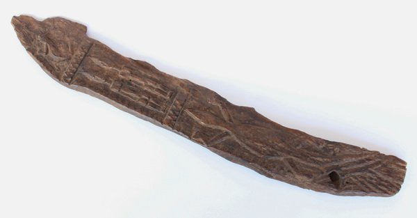 Dogon door piece, Mali: Dogon door piece, Mali, the carved hardwood embellished with relief decoration of a frog and alligator between a figural couple, symbols of protection, 30.5"l x 4.5"w.